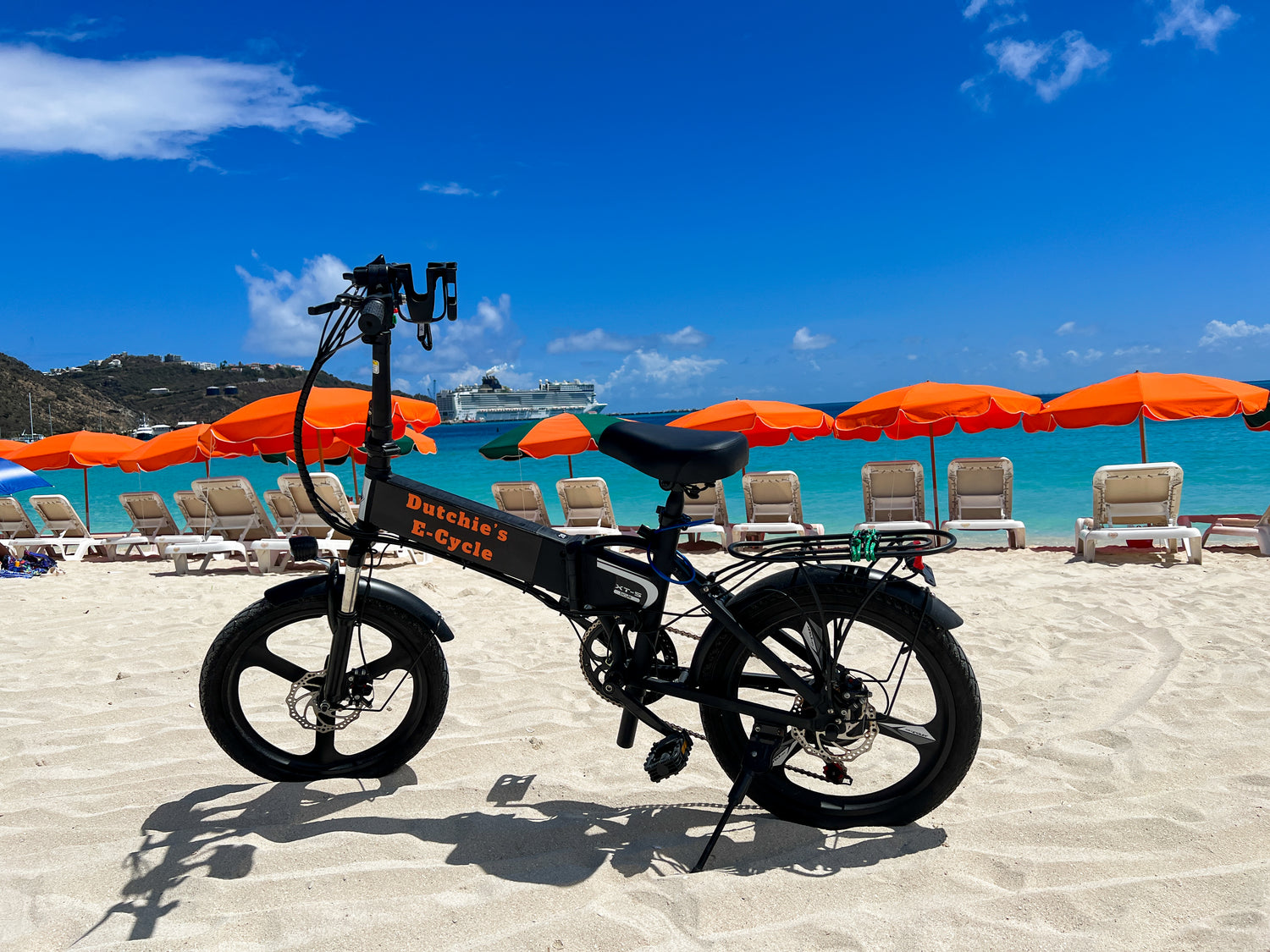 E-bike rental on beach in Sint Maarten with cruise ship in the background